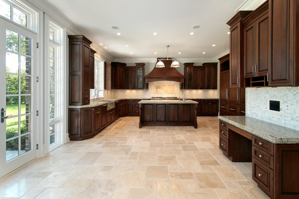 Tile flooring in a large kitchen with wood cabinetry by Nampa Floors & Interiors in Boise, ID and Nampa, ID