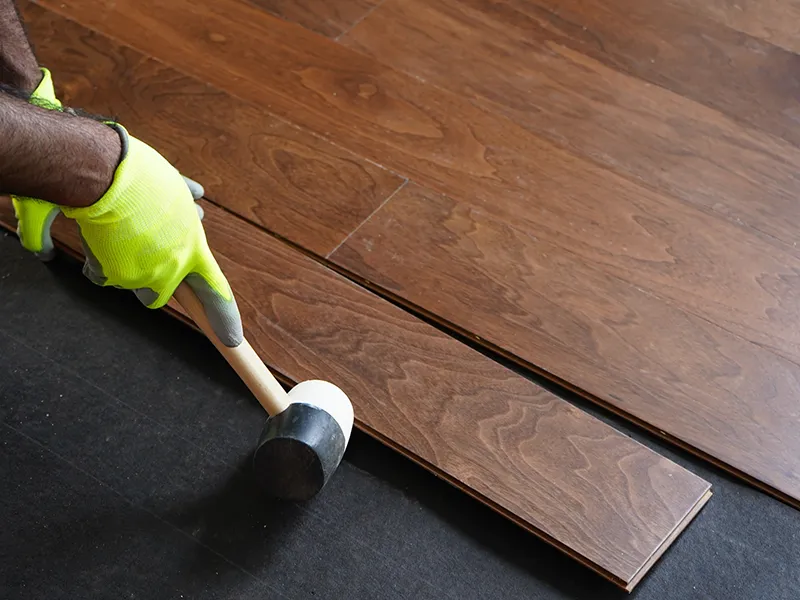 Hardwood-Installation Worker installing hardwood flooring | Nampa Floors
