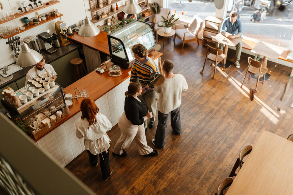 overhead view of a busy counter at a cafe with wood-look flooring