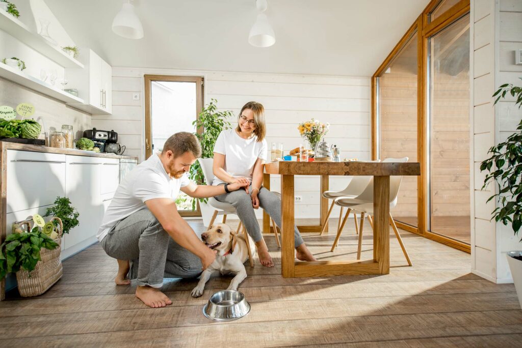 couple petting large dog with luxury vinyl flooring