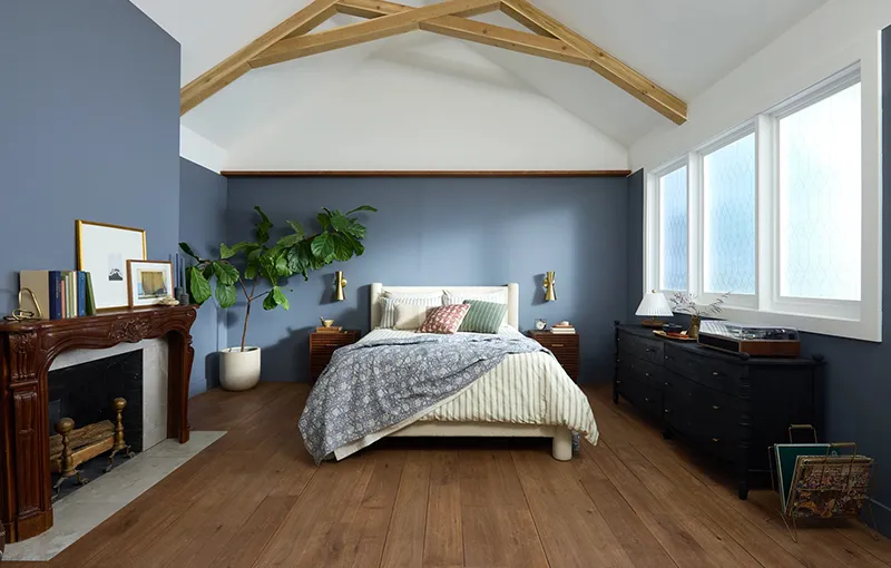 Warm rich wood look LVP in bedroom with blue walls